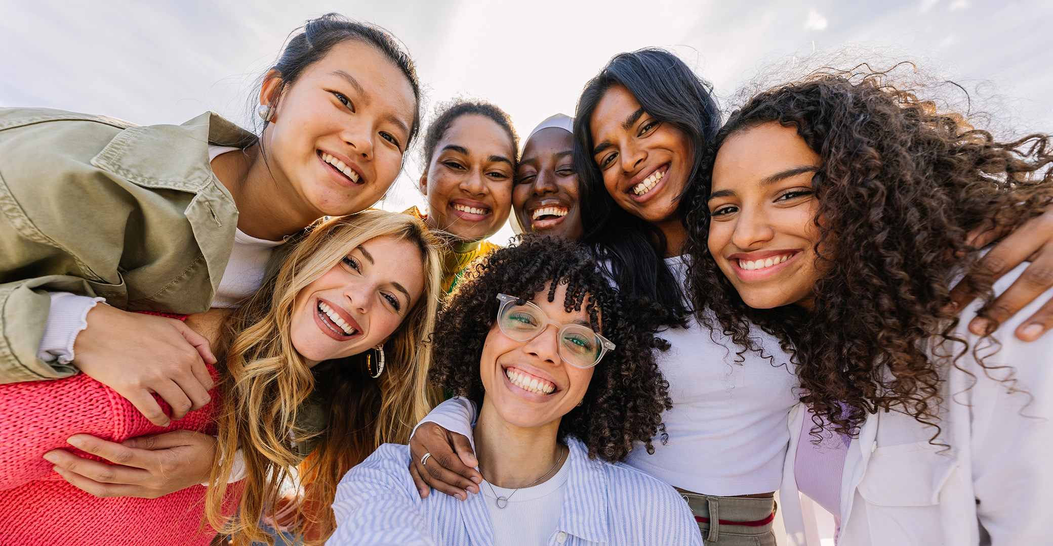 diverse group of happy young women laughing and smiling