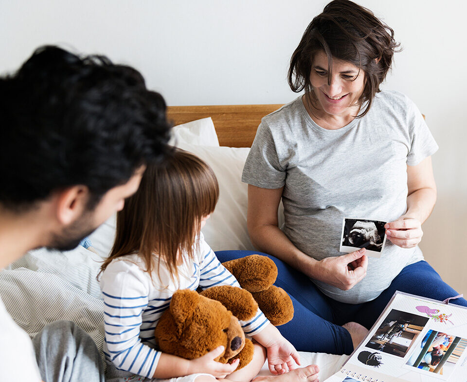 pregnant family with ultrasound photo